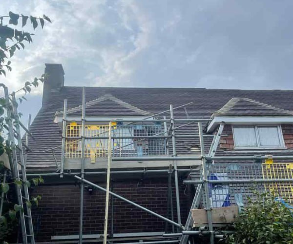 This is a photo of a roof with two dormers that is having some damaged tiles replaced. Works carried out by DHG Roofing Shefford