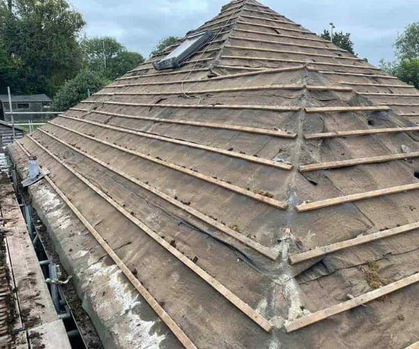 This is a photo of a hip roof that has been stripped back to the battens, and is awaiting a new roof covering to be installed. Works carried out by DHG Roofing Shefford